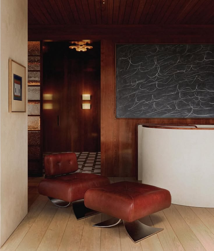 A design-led interior - a leather lounge chair against a dark timber wall
